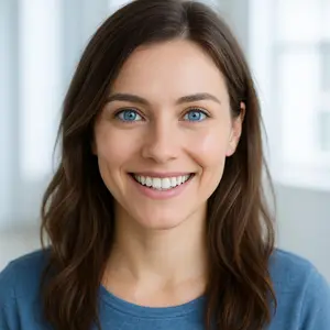 A smiling woman with brown hair and blue eyes
