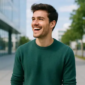 A man with short hair and a beard is smiling and seems to be posing for a photo.