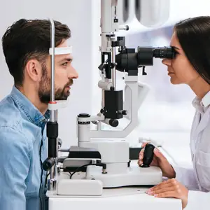 man having his eyes examined by a woman doctor