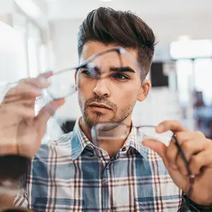 A man trying on glasses in a store