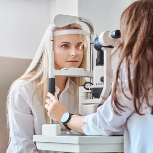 A woman is getting her eyes checked by an optometrist at the clinic.