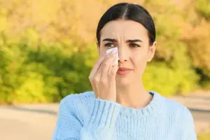 Woman wiping her eyes with a tissue
