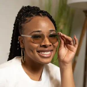 woman adjusting glasses and smiling