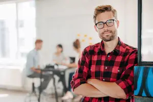 Man in glasses smiling, representing Eye E Optical eye care services in Fontana and Riverside.