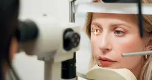 Close-up of woman receiving eye disease screening with advanced optometry tools.
