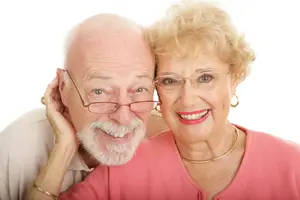 Smiling senior couple wearing eyeglasses, representing reliable optical services in Riverside