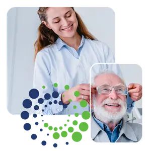 Optometrist adjusting elderly male patient's glasses