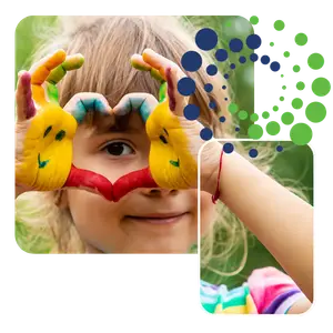 little girl with paint on her hands smiling at the camera