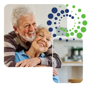 Happy senior couple smiling at each other in a kitchen