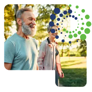Senior couple smiling and walking in a park on a sunny day