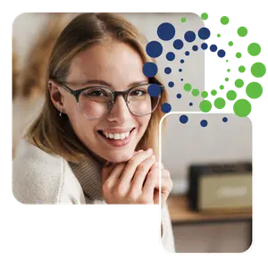 woman wearing glasses smiling at the camera