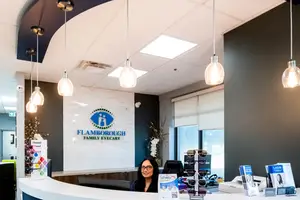 Flamborough Family Eyecare receptionist desk with a woman sitting behind it