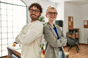 A man and a woman wearing stylish eyeglasses, showcasing modern eyewear options at Parkway Eyecare Idaho Falls.