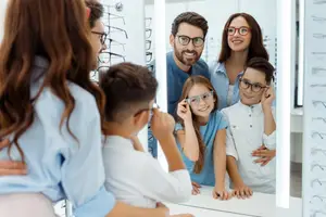 Family trying on glasses at an optical shop
