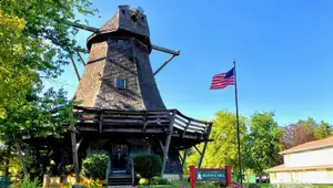 Pleasant View Mill with American flag and sign in front of it