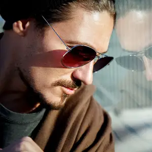 bearded young man modeling stylish sunglasses