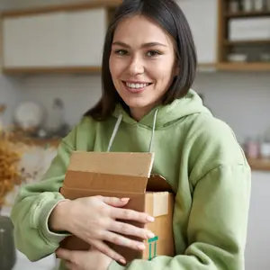 smiling woman holding delivery of contacts