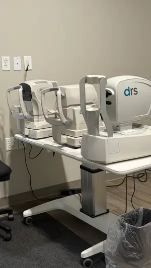 Medical equipment including an DRS machine is on a rolling table in a room.