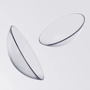 Two clear transparent contact lenses with black edges floating on a white background