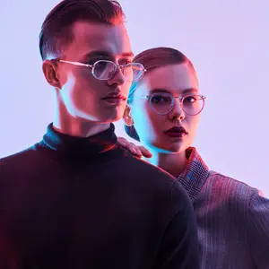 Man and woman wearing glasses posing for a picture