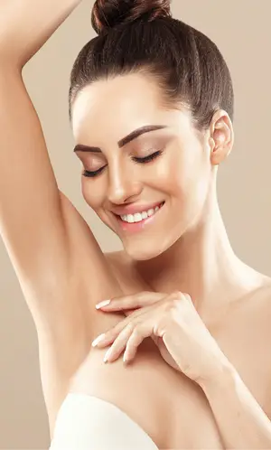 Beautiful smiling woman with white nail polish touching her shoulder