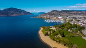 An aerial view of a beach and a city by the water