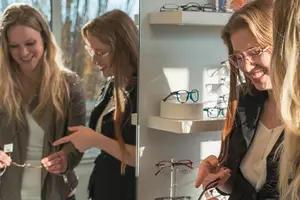 Three women in a glasses store looking at and holding glasses, with one woman wearing a necklace and another wearing a ring and jacket.
