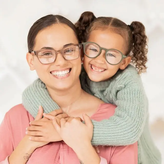 Mother and daughter in glasses hugging