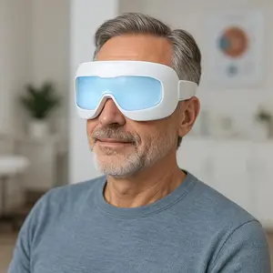 A man wearing a white LED light eye mask, looking at the camera with a slight smile.