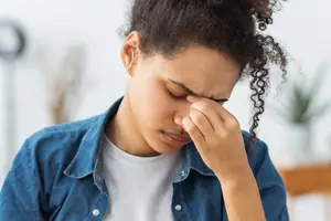 African American woman covering her face with her hand