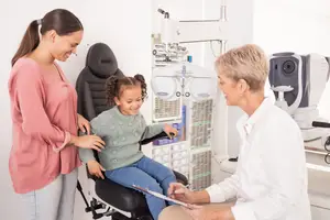 A young girl is having an eye examination with a doctor in a clinic
