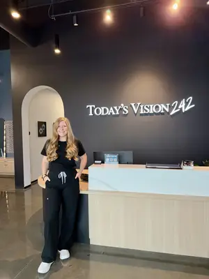 woman standing in front of the reception desk at Today’s Vision 242