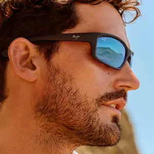 Close up of a man wearing sunglasses looking at the horizon