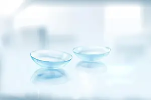 Two transparent glass bowls placed on a white surface with reflections.