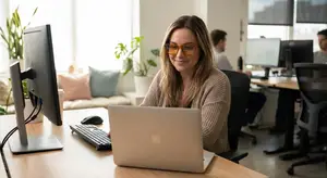 woman working at a desk with a computer