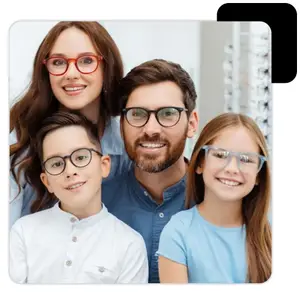 A family with two children and two adults wearing glasses are smiling in front of a black background