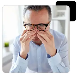 A man adjusting his glasses and touching his nose