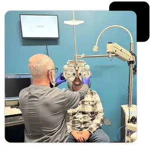 An ophthalmologist examining a patient with an eye machine in a clinic room