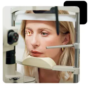 Woman getting an eye exam with an ophthalmoscope