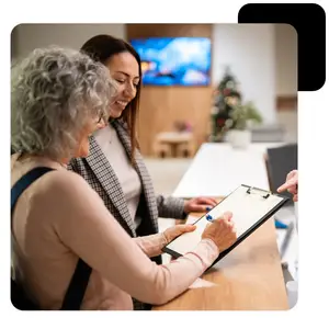 Woman holding a clipboard and talking to a client