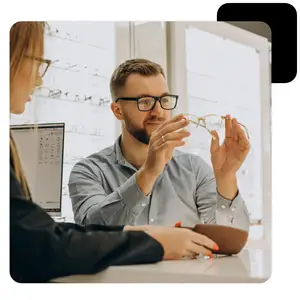 Optometrist shows customer a pair of glasses