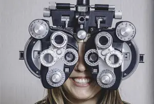 Woman undergoing an eyes exam and smiling