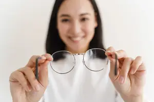 woman holding glasses