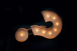 Question mark with lights on a black background
