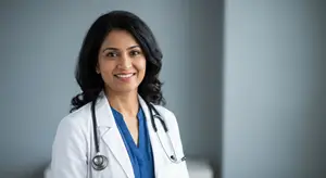 A smiling woman doctor with a stethoscope around her neck