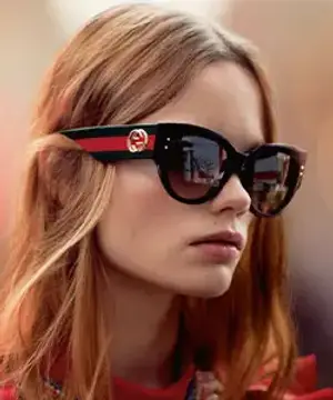 Blonde woman wearing sunglasses with the Gucci logo