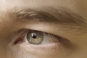 Close-up of a young boy's eye with a blurry background