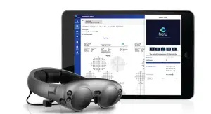 A tablet computer displaying the Heru app is shown with a pair of VR glasses next to it.