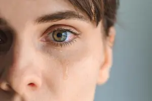 Close up of a woman with tears streaming down her face