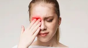 woman touching her face and looking in pain